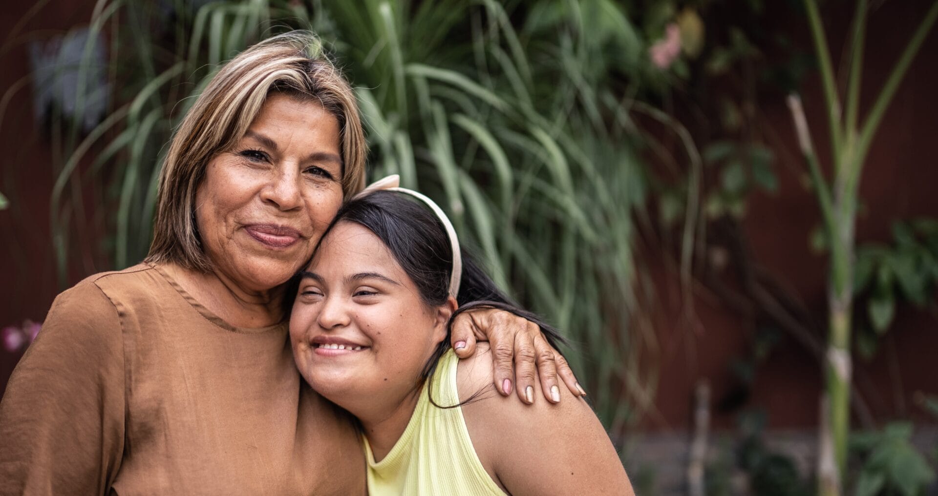 Photo of a woman embracing a young girl
